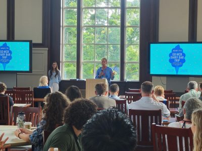 MCB Dept. Head, Adam Zweifach standing behind podium welcoming attendees to the MCB Research Exchange