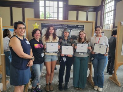 Awward winners with their PI standing with their certificates