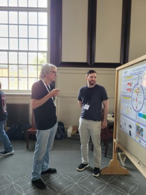Faculty and student in front of research poster