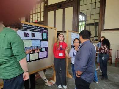 students standing in front of research poster