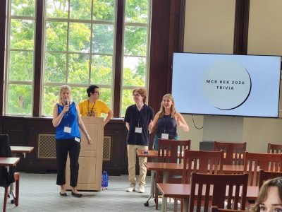 Students announcing trivia behind the podium
